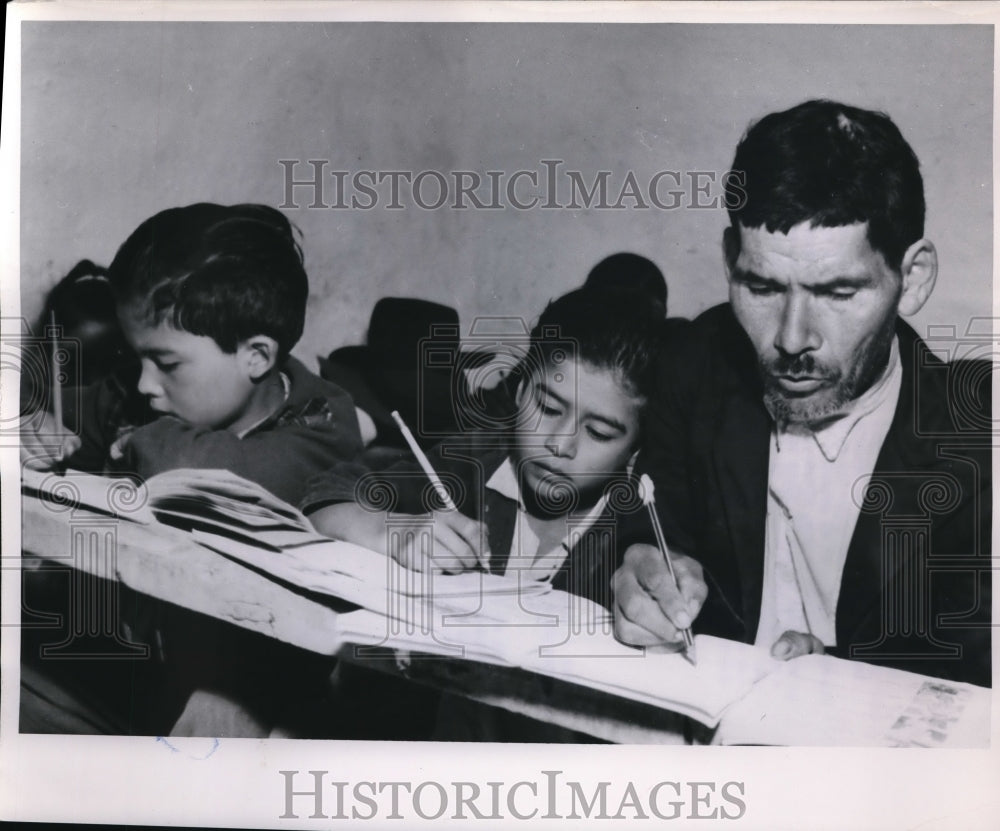 1952 Press Photo Father Joaquin Salcedo Writing a Lesson At Guavita Radio School