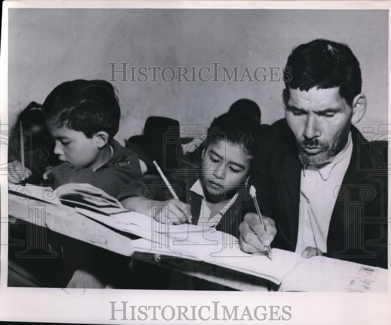 Load image into Gallery viewer, 1952 Press Photo Father Joaquin Salcedo Writing a Lesson At Guavita Radio School
