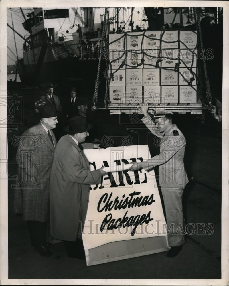 Load image into Gallery viewer, 1953 Press Photo Paul Comly French Director of care hands cargo manifest to

