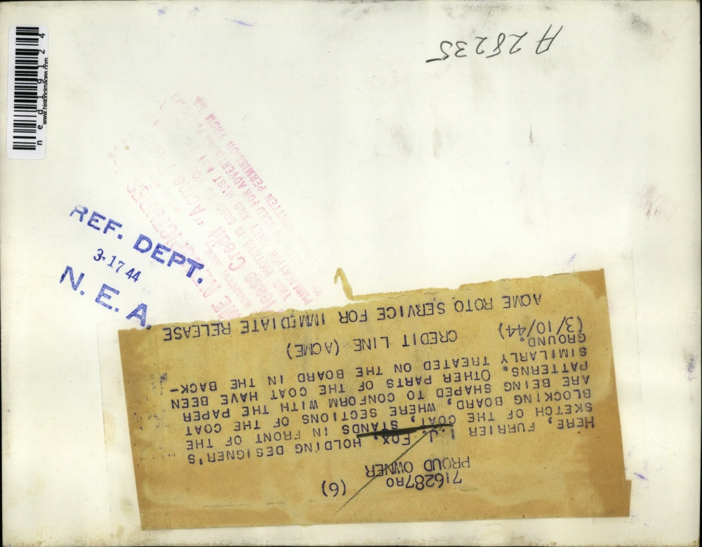 1944 Press Photo I.J Fox holding designer's sketch of the coat