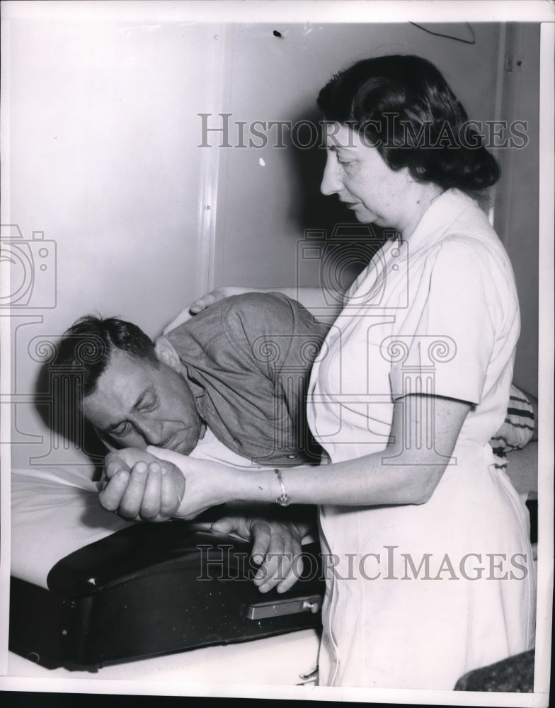 Load image into Gallery viewer, 1953 Press Photo Nurse Lotte Pate giving first aid to Martain Pollack
