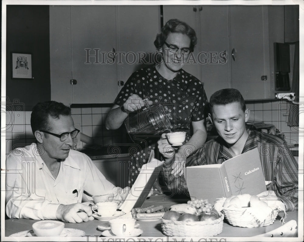 1956 Press Photo Father And Son Both Study While Having Breakfast