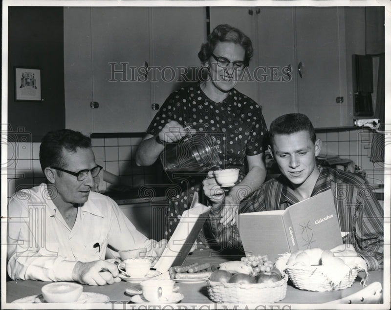 Load image into Gallery viewer, 1956 Press Photo Father And Son Both Study While Having Breakfast
