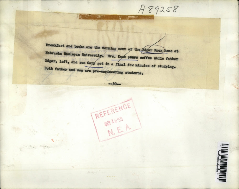 1956 Press Photo Father And Son Both Study While Having Breakfast