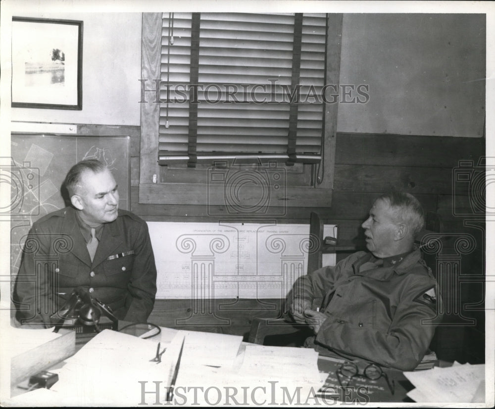 1942 Press Photo Noel Harrison sits behind the desk of Gen. Charlels Scott