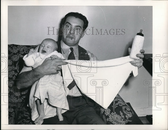 1948 Press Photo Gene Pertine Also Known As Butch Changing A Crying Baby