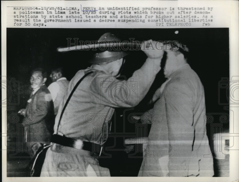 1961 Press Photo Lima Peru an unidentified professor is threaten by a policeman