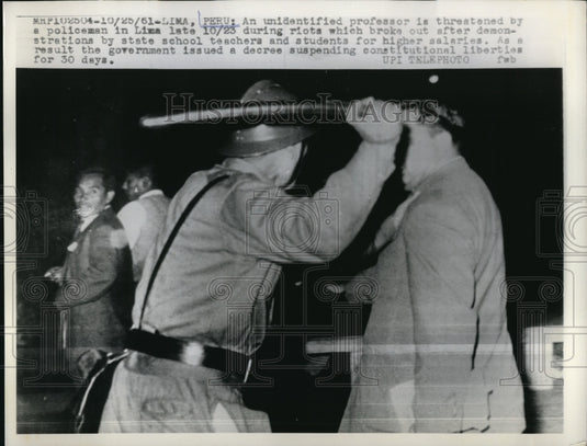 1961 Press Photo Lima Peru an unidentified professor is threaten by a policeman