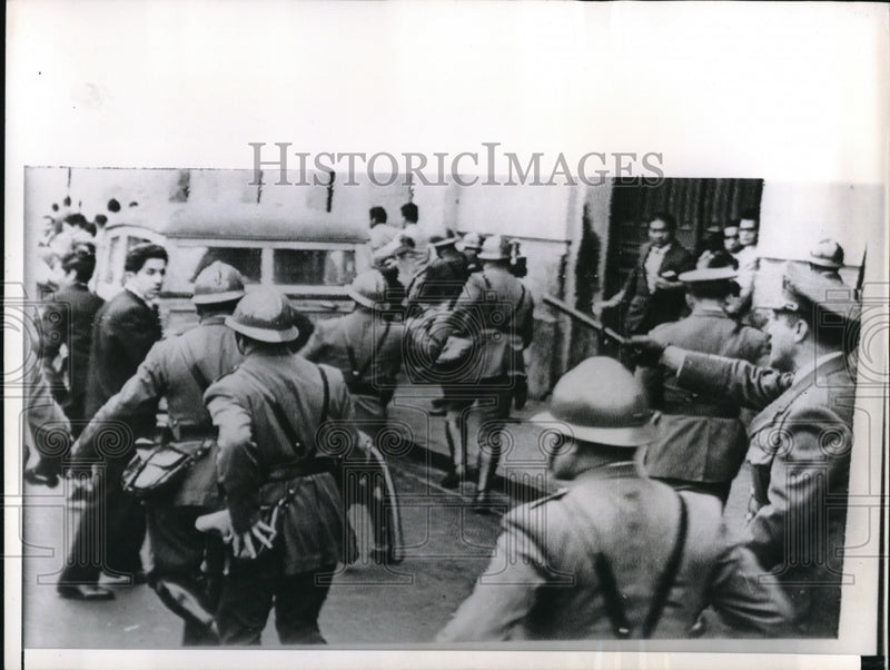 Load image into Gallery viewer, 1961 Press Photo Lima Peru Police using tear gas and clubs break up street fight
