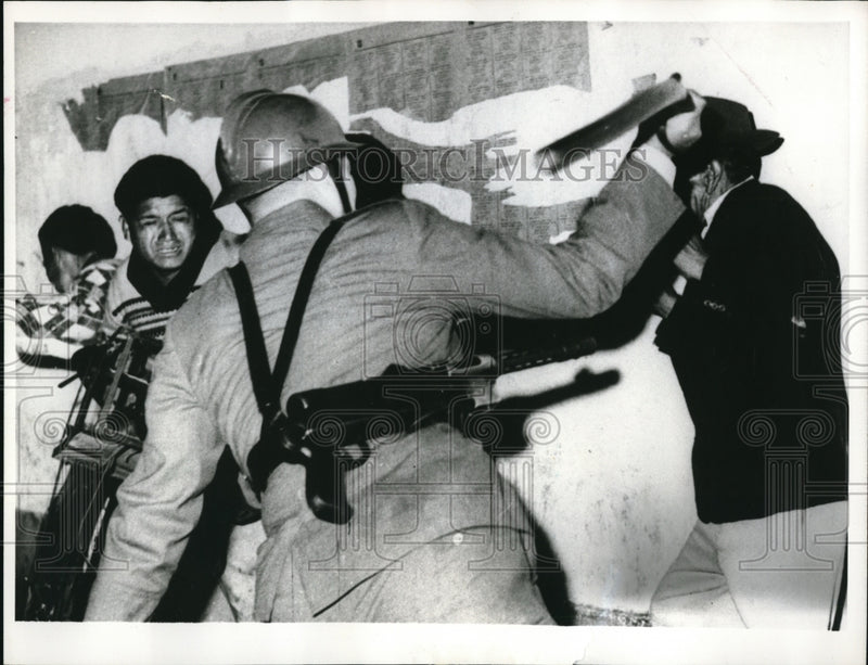 Load image into Gallery viewer, 1964 Press Photo Lima Peru Swinging truncheon Peruvian policeman wades into
