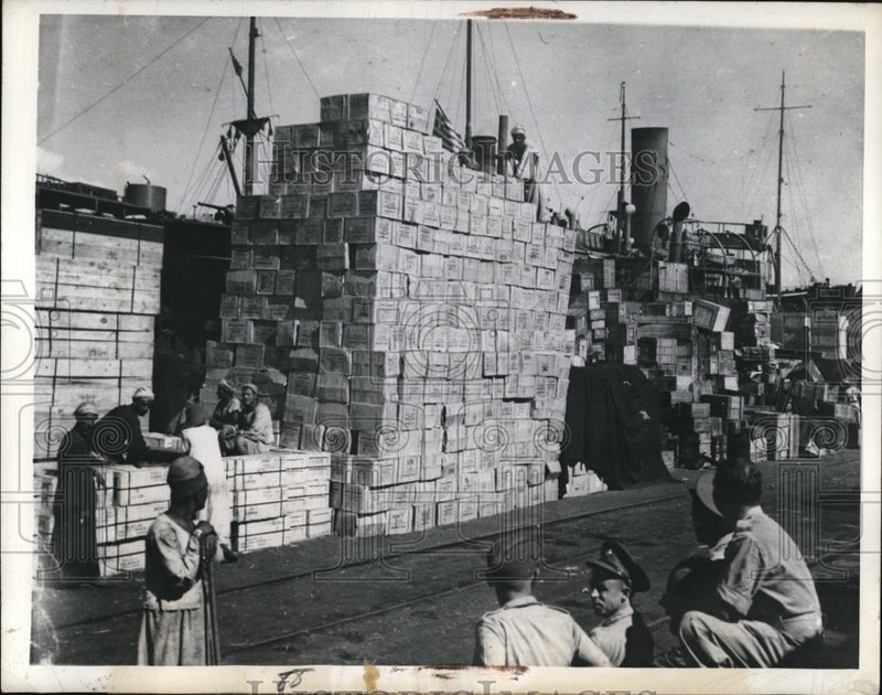 Load image into Gallery viewer, 1943 Press Photo Cases of foodstuff unloaded in Middle East port for UN troops
