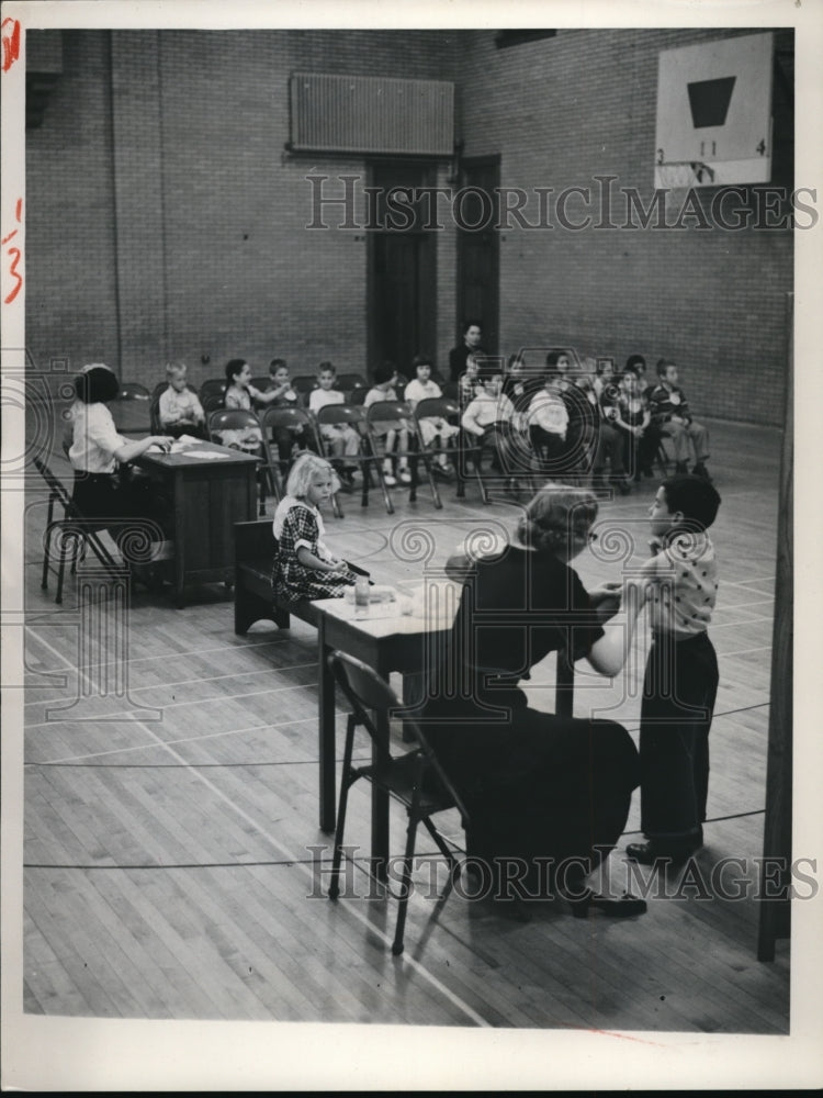 Load image into Gallery viewer, 1955 Press Photo Children Receiving Shots In School Gym
