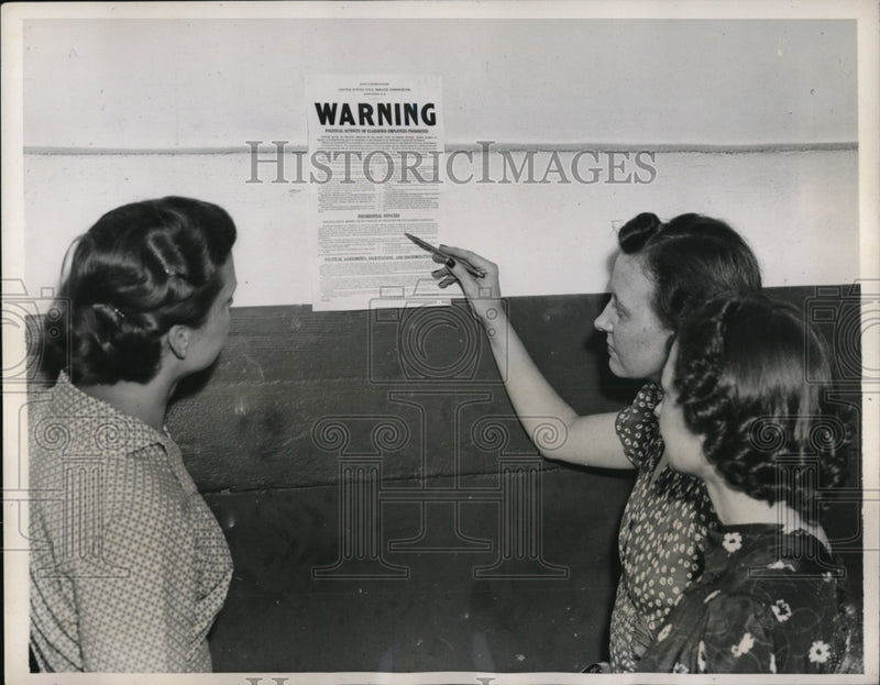 Load image into Gallery viewer, 1938 Press Photo Wash DC Civil Service workers at poster of regulations
