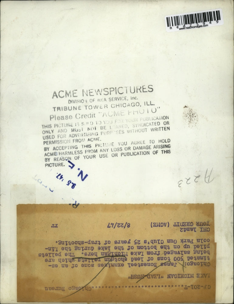 1947 Press Photo James Bonesteel Examines 500 Tons Of Lead Shotgun Pellets