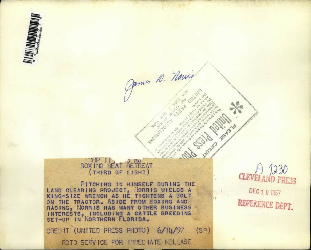 1957 Press Photo pitching in on land clearing project Norris wields king size