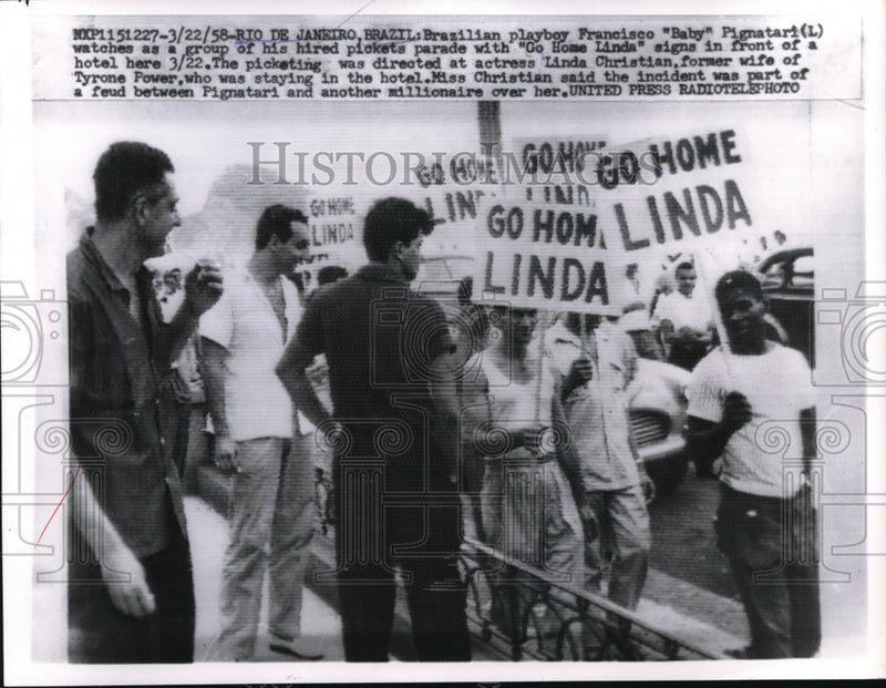 Load image into Gallery viewer, 1958 Press Photo Brazilian playboy Francisco "Baby" Pignatari in front of picket
