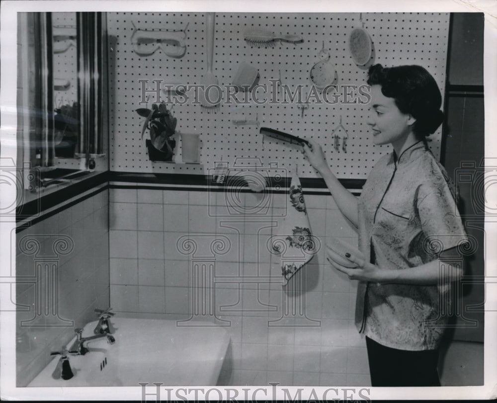 1954 Press Photo Wife creates pegboard for bathroom cleanliness tools- Historic Images