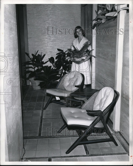 1957 Press Photo Brilliant yellow chairs in black