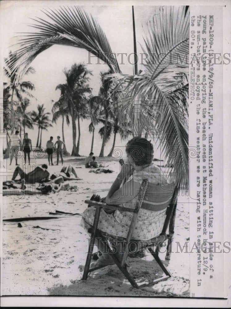 1958 Press Photo Woman Enjoying Beach Weather in Miami, Florida.