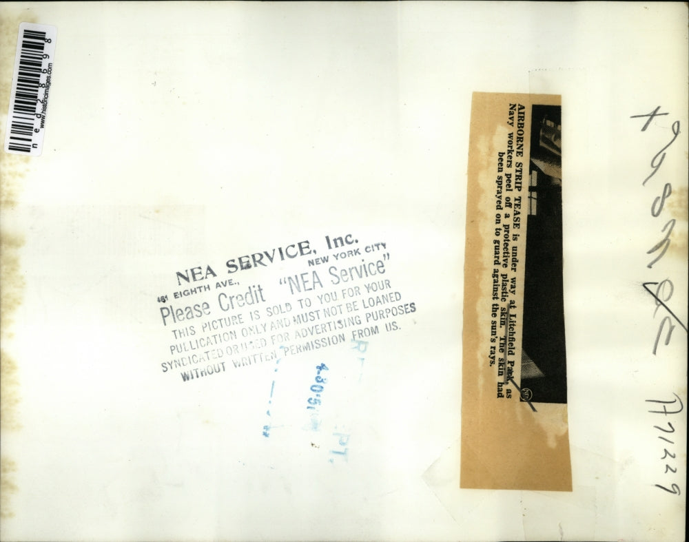 1950 Press Photo Navy Workers Peel Off Protective Plastic Skin