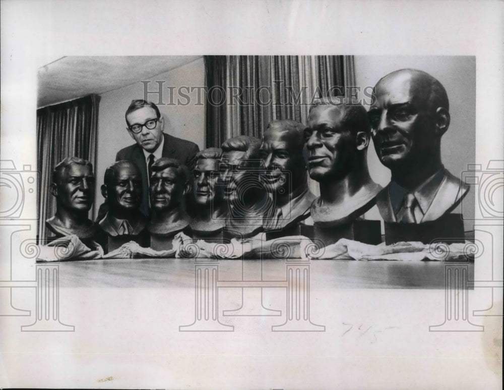 1967 Press Photo Life-sized busts of football players checked by Dick McCann