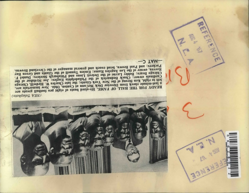 1967 Press Photo Life-sized busts of football players checked by Dick McCann