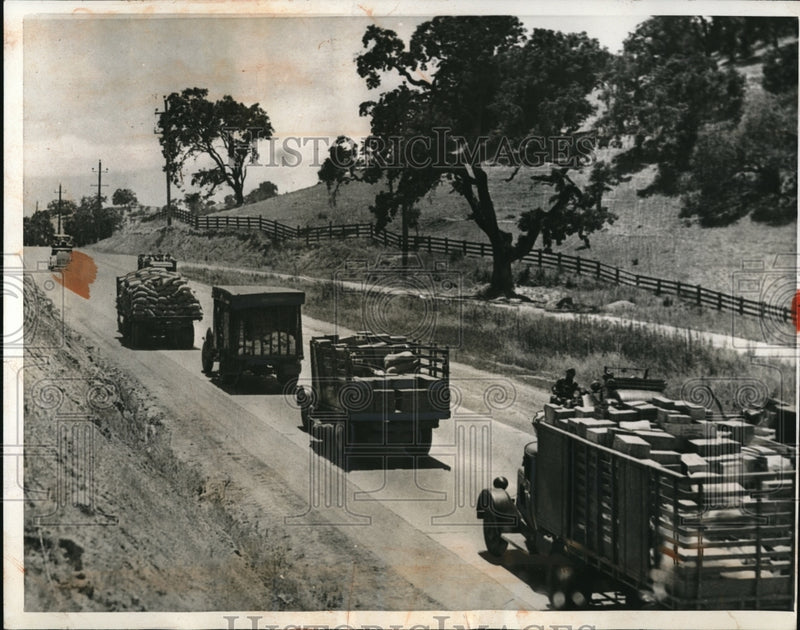 Load image into Gallery viewer, 1934 Press Photo Truck Caravan of Emergency Food
