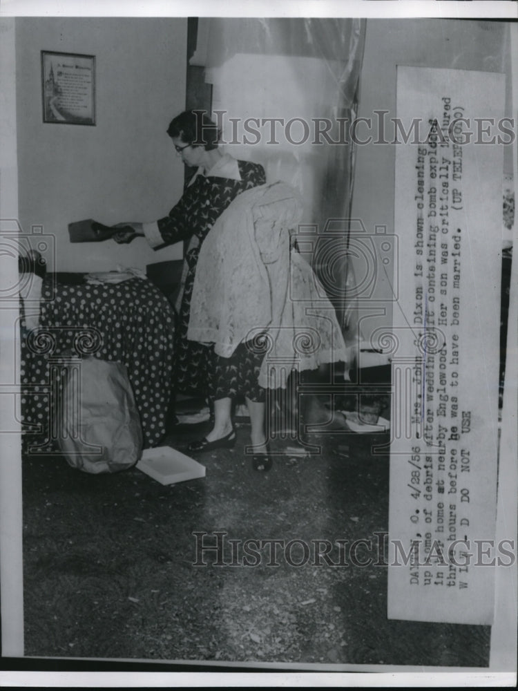 1956 Press Photo Mrs John G Dixon cleaning up debris of wedding gift bomb