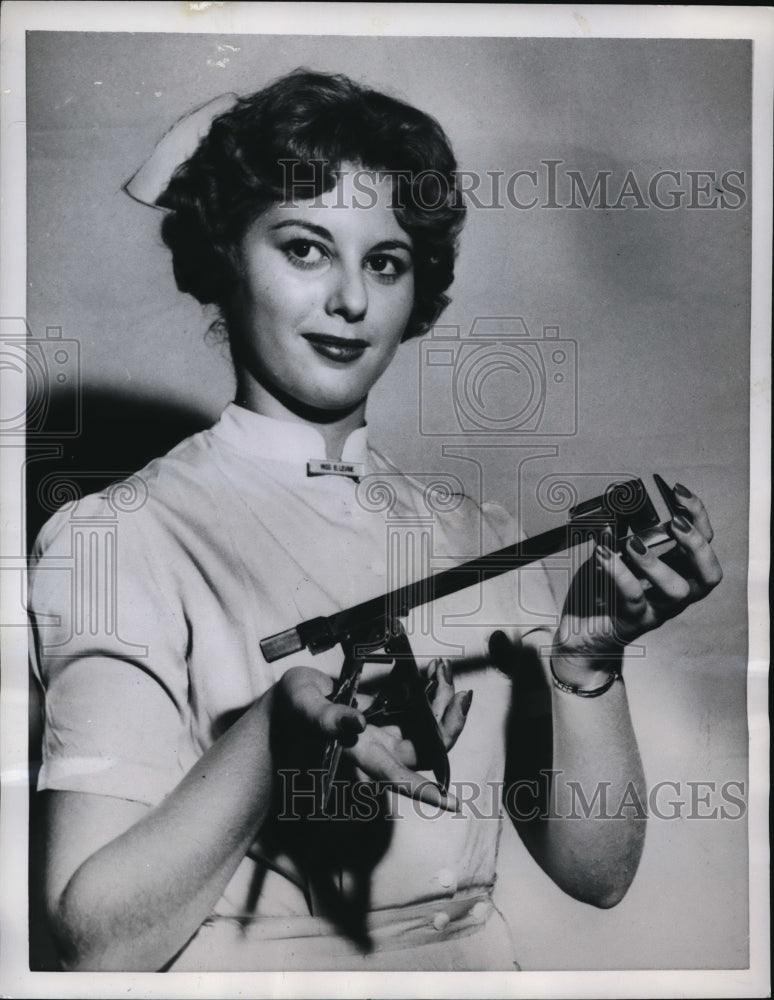 Load image into Gallery viewer, 1959 Press Photo Barbara Levine with a surgical stapling machine.
