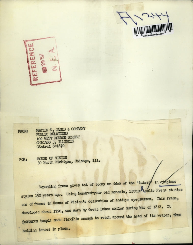 1957 Press Photo Leslie Frega at the House of Vision's looking at antique frames