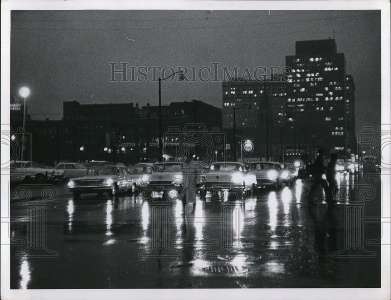 Load image into Gallery viewer, 1963 Press Photo Darkness sets in on a rainy day lights in office building are
