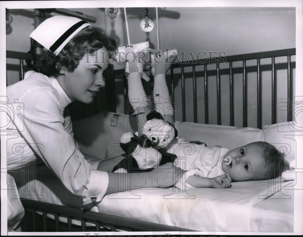 1957 Press Photo Peter Makrinski with broken leg with nurse Shirley Samelson