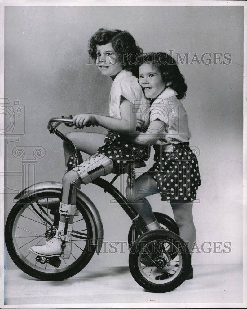 Load image into Gallery viewer, 1953 Press Photo Judy Schutkesting rides a bike with sister Joyce - ned33770

