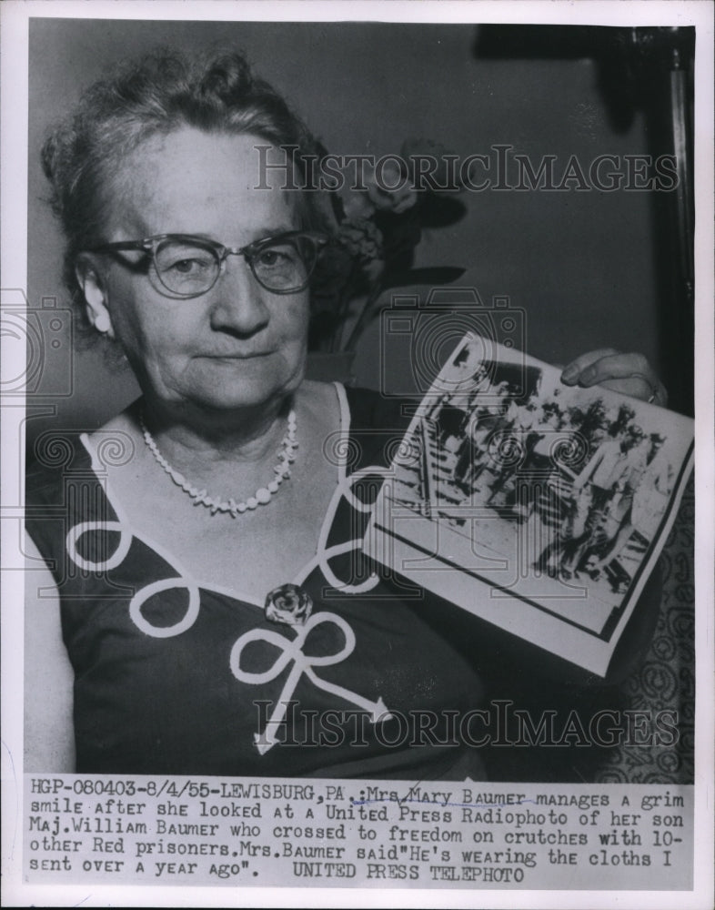 1955 Press Photo Mrs. Mary Baumer looked at the photo of her son