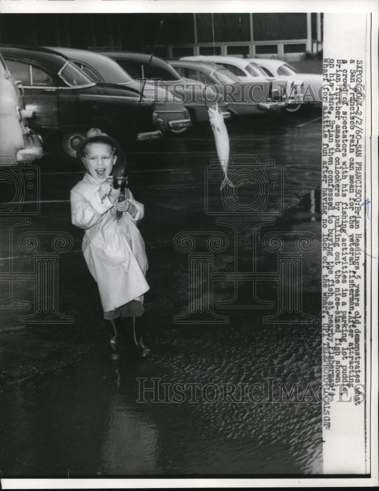 1960 Press Photo Brian Headings fishing in puddle
