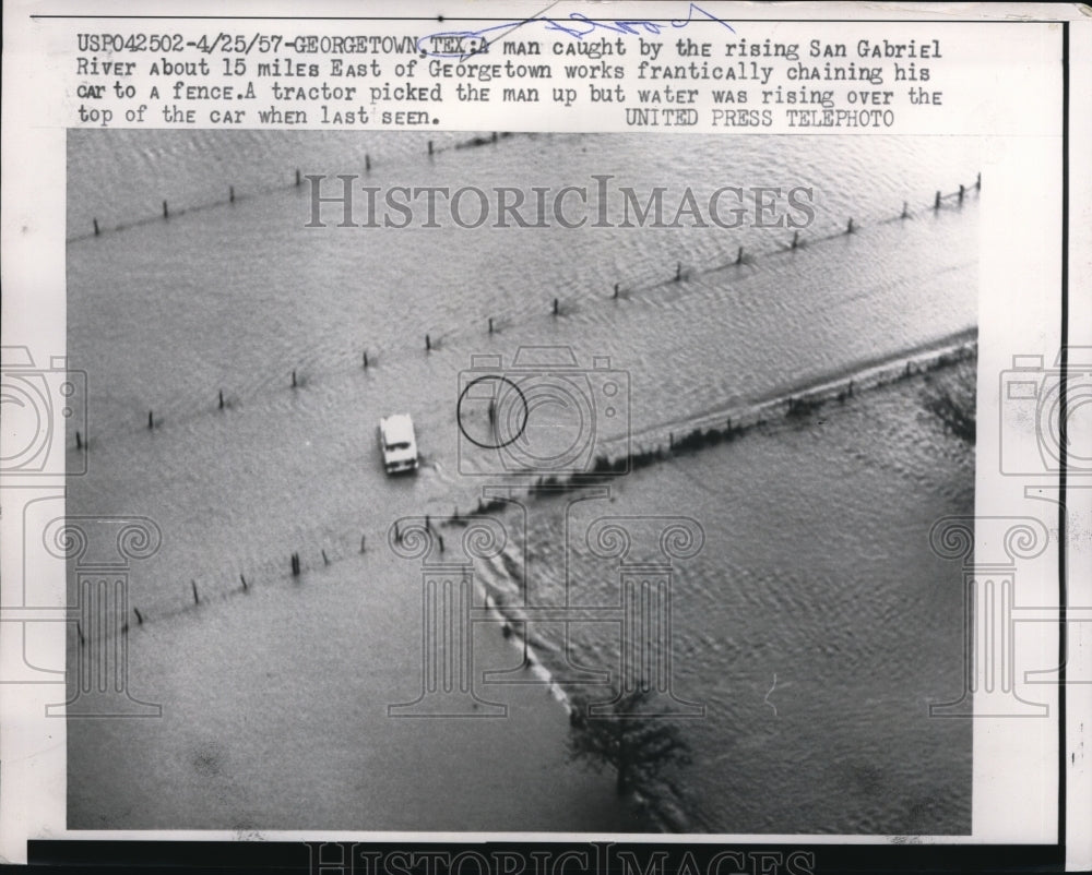 1957 Press Photo Man caught by the rising San Gabriel Rivers in Texas.