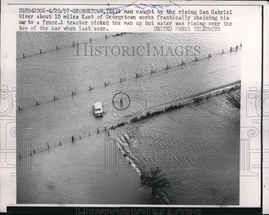 1957 Press Photo Man caught by the rising San Gabriel Rivers in Texas.