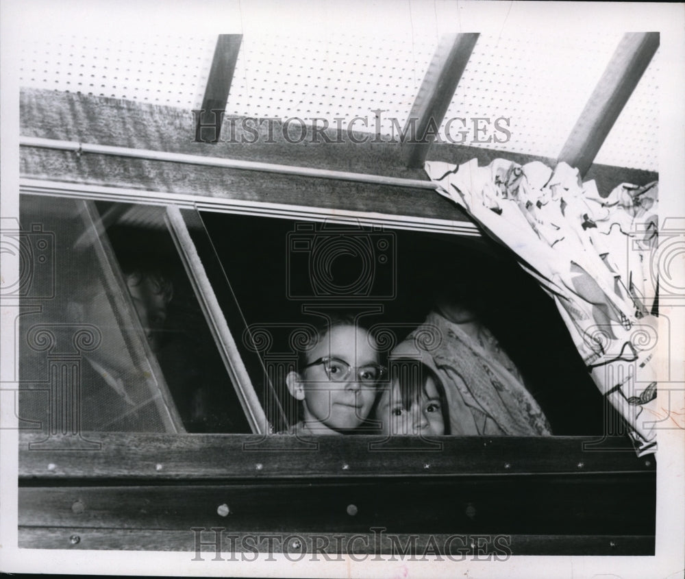 1959 Press Photo Darlene Miller & Mary Miller peak out of a window