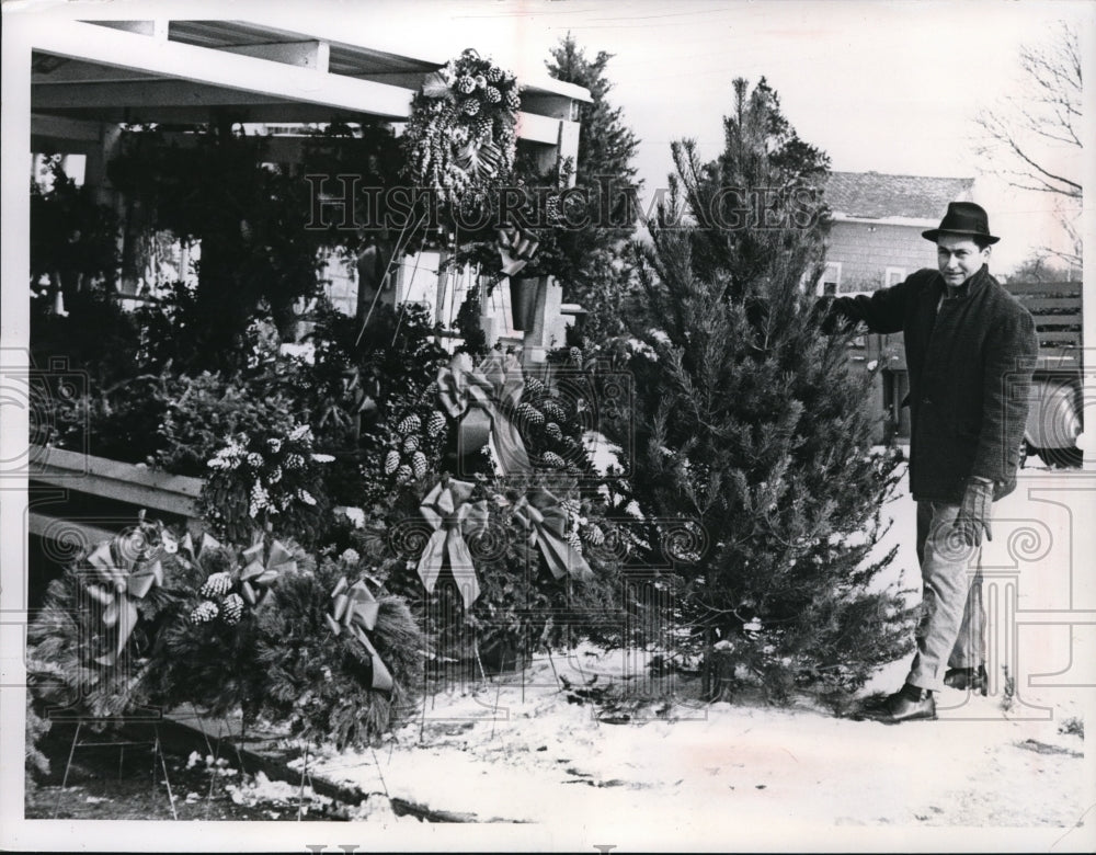 1963 Press Photo Walter Majcher posing in front of a Christmas display