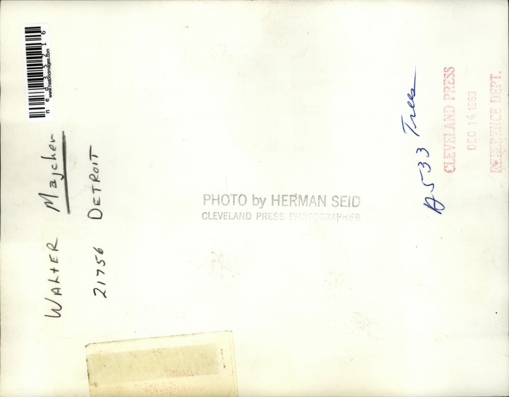 1963 Press Photo Walter Majcher posing in front of a Christmas display