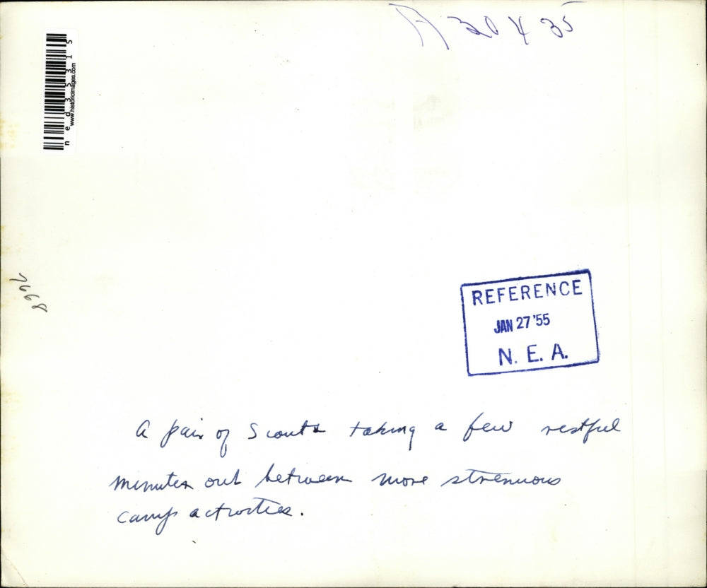 1955 Press Photo Pair of scouts taking a break between camp activities