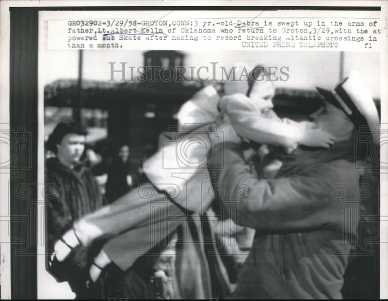 Load image into Gallery viewer, 1958 Press Photo Debra Kelln Is Swept Up By Father, Lt. Albert Kelln
