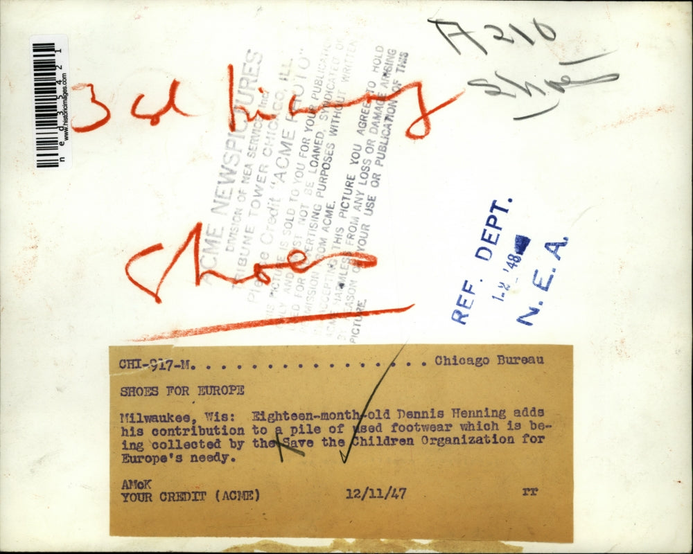 1947 Press Photo Dennis Henning adds contribution to pile of used footwear