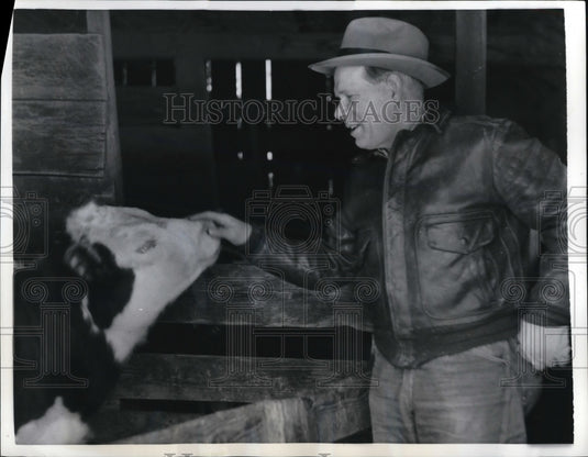 1957 Press Photo Farmer in the Dark