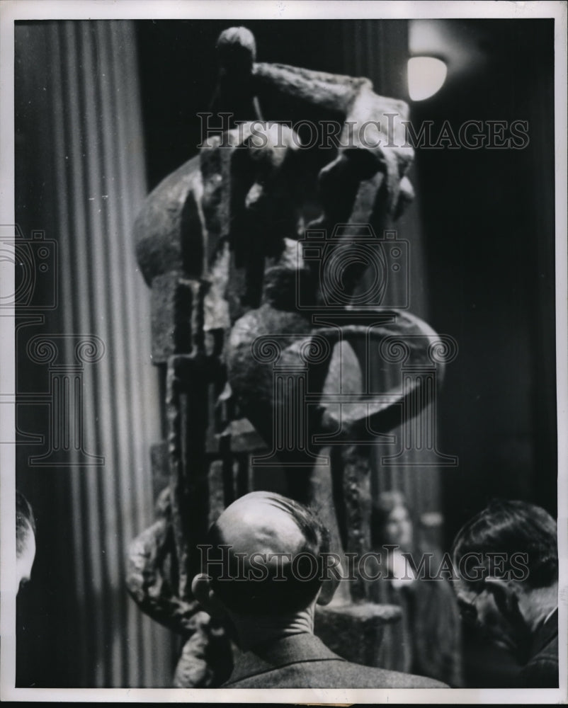 1952 Press Photo A baldheaded man studies complex modernistic sculpture while