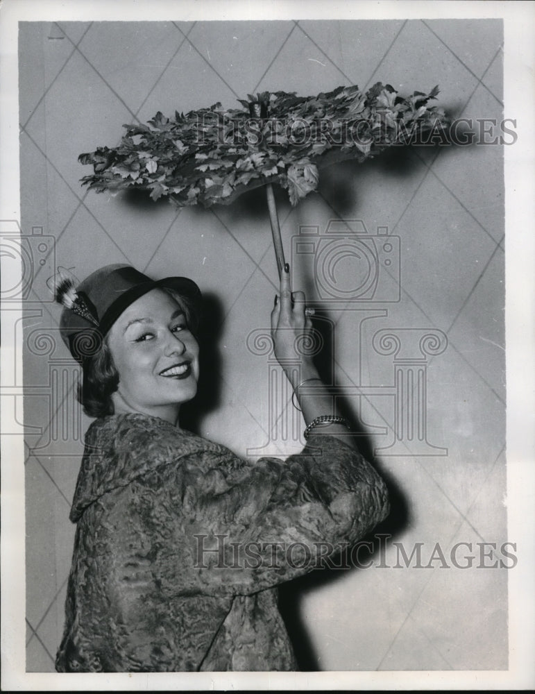 Load image into Gallery viewer, 1957 Press Photo Model poses with an umbrella bedecked with Autumn leaves
