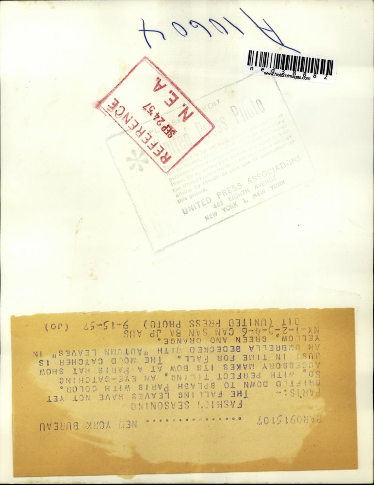 1957 Press Photo Model poses with an umbrella bedecked with Autumn leaves