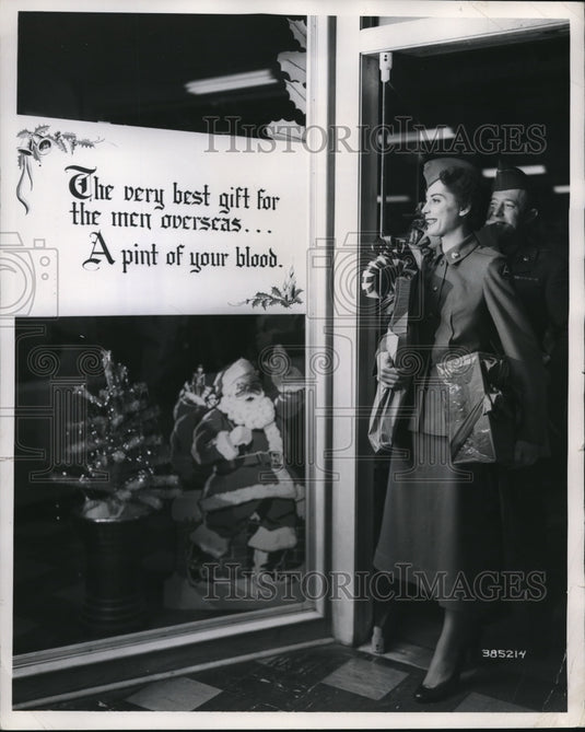 1951 Press Photo Dorine Hamelin and Corporal Douglas Adams donate blood
