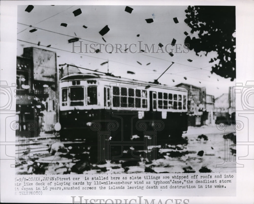 1950 Press Photo Slate tilings are being whipped off roofs and into the air