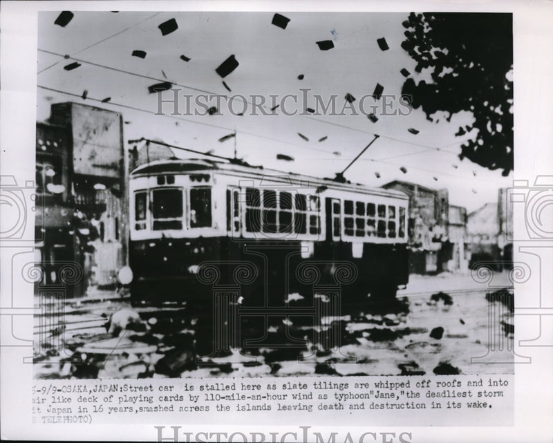 Load image into Gallery viewer, 1950 Press Photo Slate tilings are being whipped off roofs and into the air
